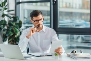 professional translator working with documents and laptop in off